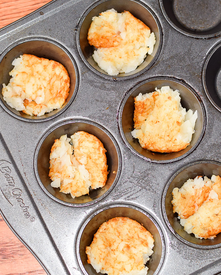 Place thawed hash brown pieces into muffin tins