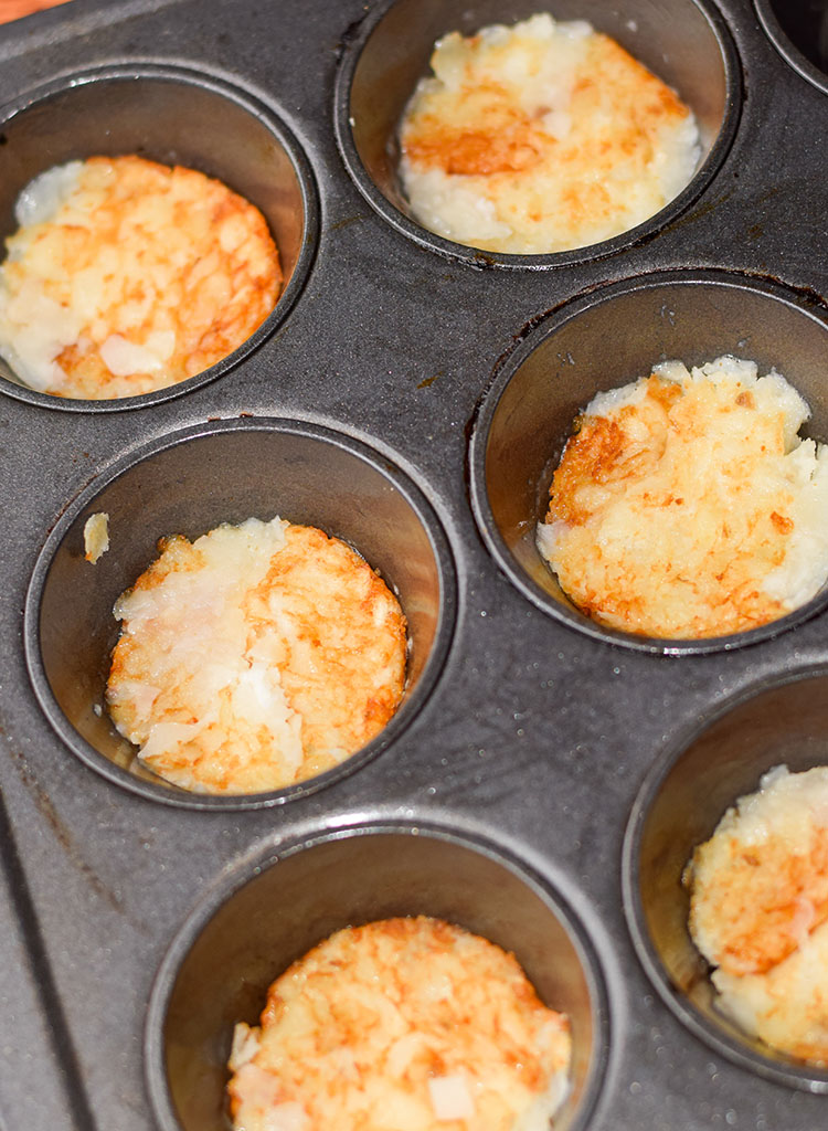 Hash browns settled in the muffin cups